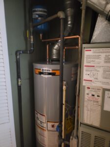 Professional gas water heater installation with copper piping in an Olney, MD residential home.